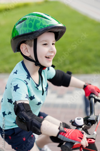 Boy in helmet with bicycle outdoor