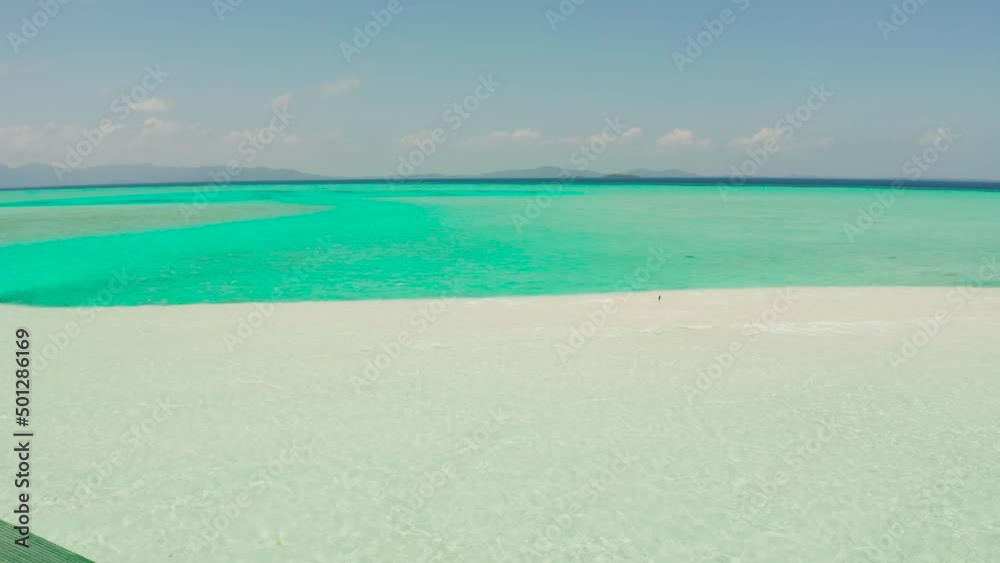 Tropical sandy beach with wave and turquoise water,copy space for text, aerial view. Sea water surface in lagoon. Transparent turquoise ocean water surface. Background texture Tropical sandy beach with wave and turquoise water,copy space for text, aerial view. Sea water surface in lagoon. Transparent turquoise ocean water surface. Background texture