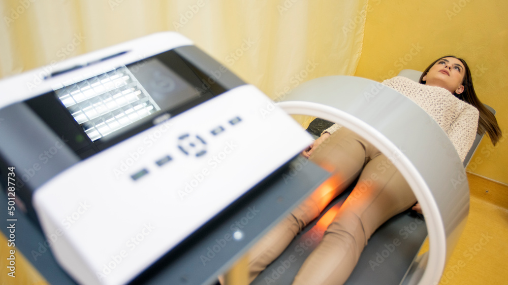 therapy system. Patient on a treatment bed with Field Therapy on her leg