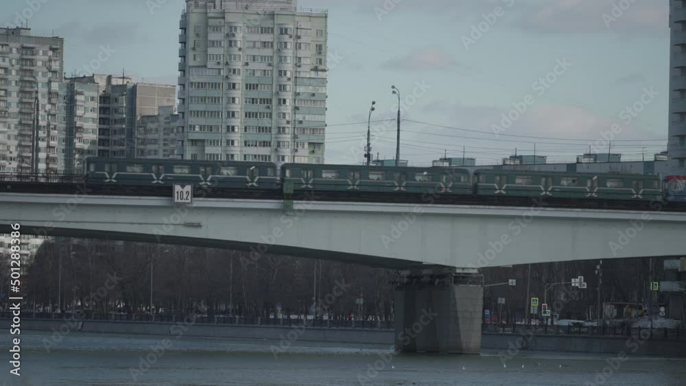 Cityscape of Moscow. The train of the city surface metro passes over the bridge over the river Cityscape of Moscow. The train of the city surface metro passes over the bridge over the river