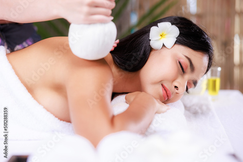 Beautiful young asian woman relaxing in the spa salon massage in the nature