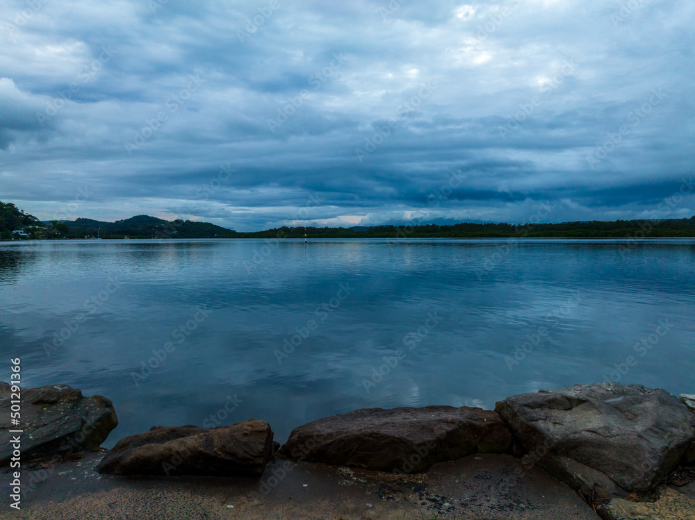 Autumn sunrise and rain clouds over the bay Autumn sunrise and rain clouds over the bay