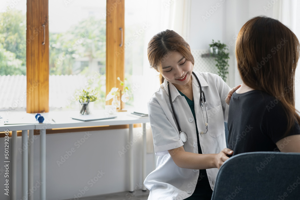 Obraz premium Female physiotherapist examining back of female patient in rehabilitation clinic. Physical therapy concept.