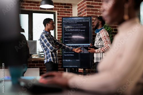 Canvas Print African american software developer pointing out cloud database processing algorithm error