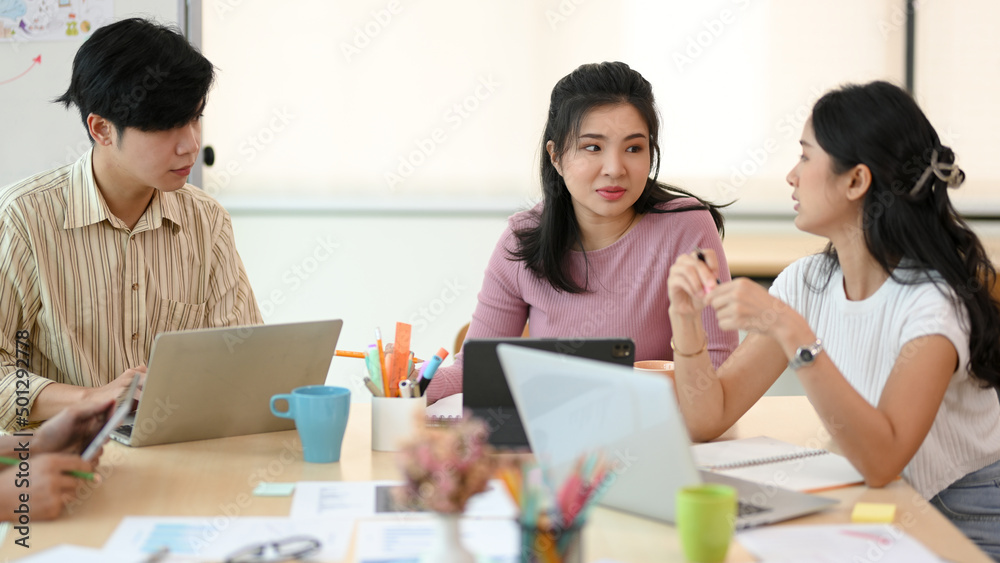 An asian young business team working together in the meeting room An asian young business team working together in the meeting room