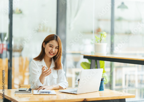 Online Meeting. Happy young woman using laptop computer for virtual conferencing, having video call at home. Cheerful Asian female communicating with colleagues, friends remotely.