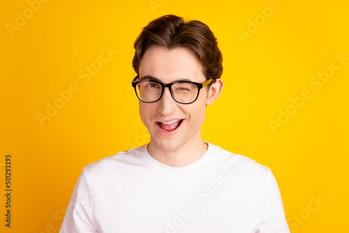 Photo of young handsome man good mood wink eye flirty date wear casual clothes isolated over yellow color background