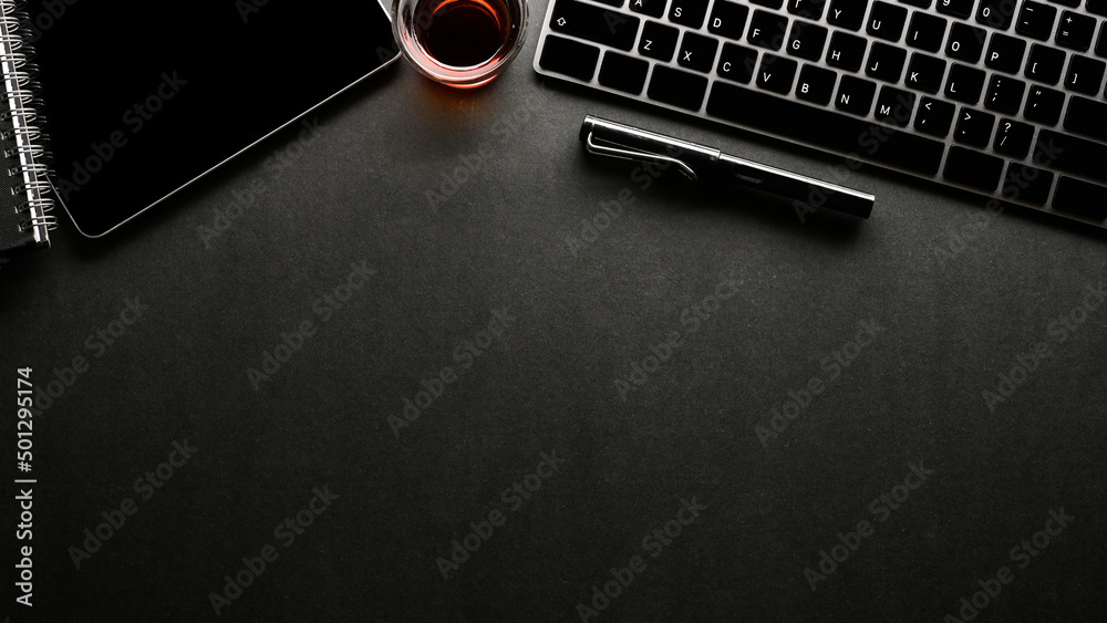 Modern black office desk top view with pc keyboard, tablet and copy space. Modern black office desk top view with pc keyboard, tablet and copy space.