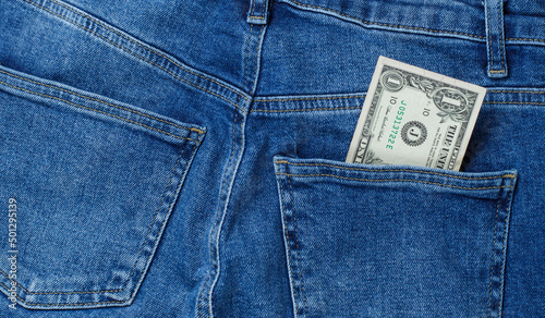 one dollar in the back pocket of jeans. money in your pocket