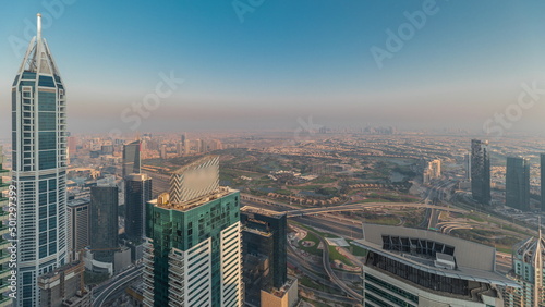 Panorama of Dubai Marina with JLT skyscrapers and golf course timelapse  Dubai  United Arab Emirates.