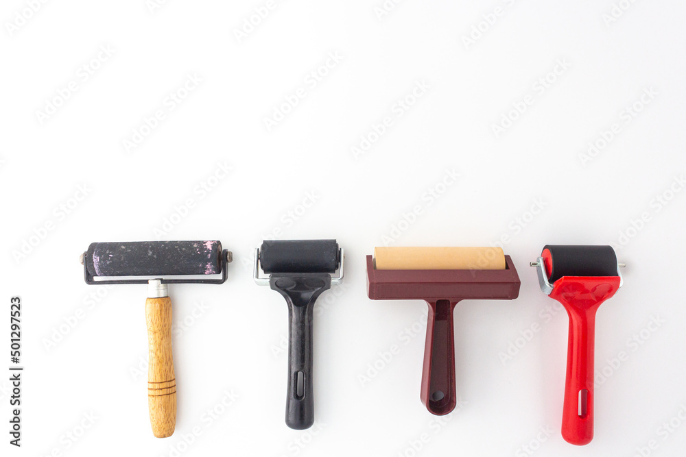 Foto de Collection of rubber brayers use in craft process on white