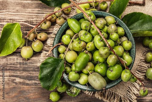 Harvest of ripe Actinidia arguta kiwi in a ceramic bowl photo