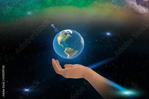 earth globe in hands on front blue starry sky nebula hold world peace concept nature background