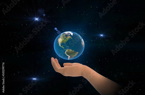 earth globe in hands on front blue starry sky nebula hold world peace concept nature background
