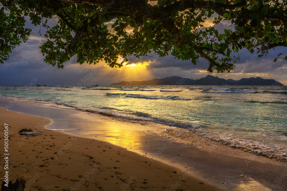 Sunset over Praslin Island seen from Anse Severe Beach at the La Digue Island, Seychelles Sunset over Praslin Island seen from Anse Severe Beach at the La Digue Island, Seychelles