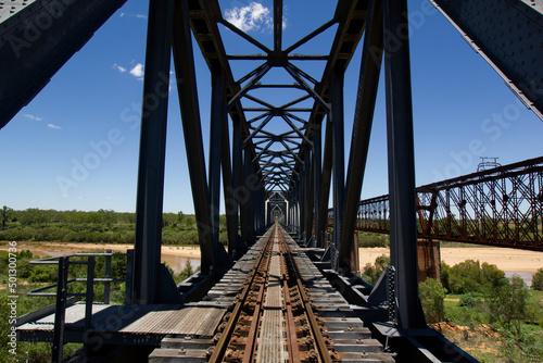 Two rail bridges over the Burdekin River at Dotswood, Queensland, Australia, with the old heritage listed Macrossan Bridge on the right.
