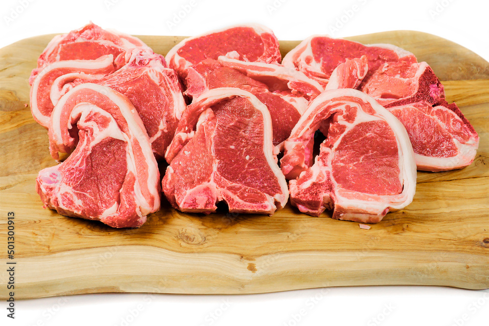 Fresh lamb chops on wooden cutting board and white background. Meat industry product. Butcher craft.