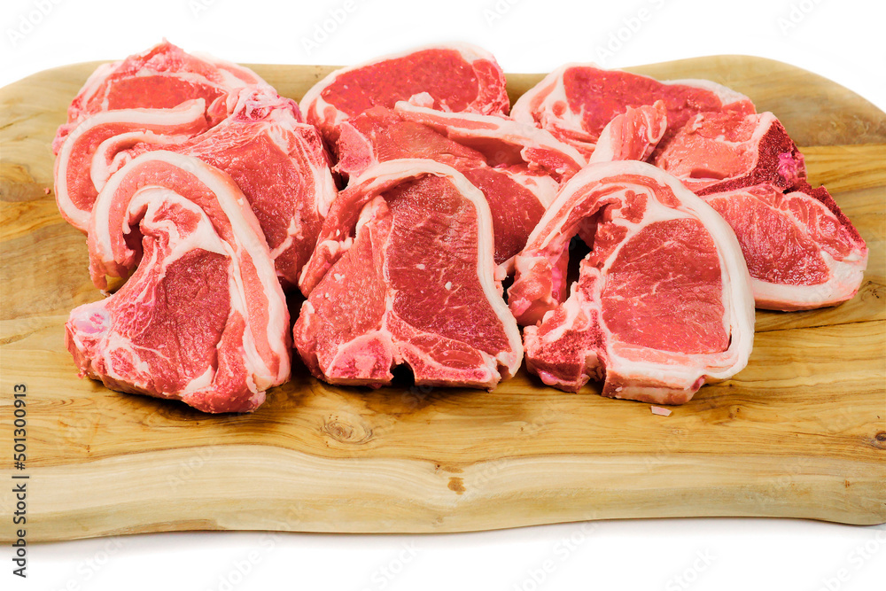 Fresh lamb chops on wooden cutting board and white background. Meat industry product. Butcher craft. Fresh lamb chops on wooden cutting board and white background. Meat industry product. Butcher craft.