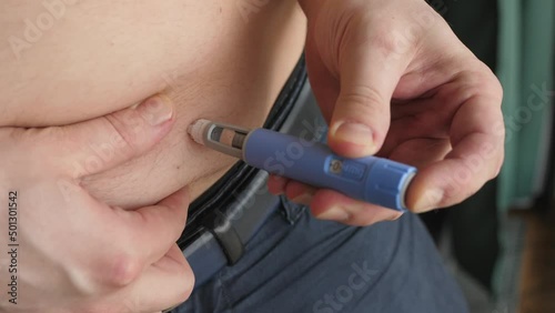 obese fat man preparing Semaglutide Ozempic injection to control blood sugar levels