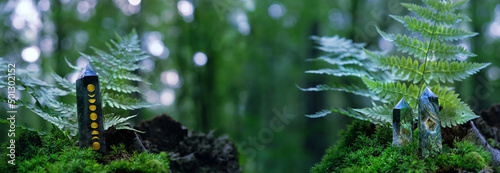 Leinwand Poster Crystals quartz towers on moss in  forest, natural green background