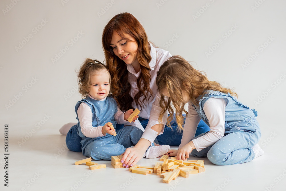 Mother plays with her daughters