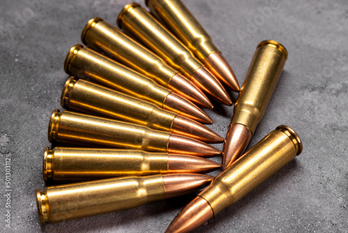 Bullets on gray background. Cartridges 7.62 caliber for Kalashnikov assault rifle. Top view, flat lay