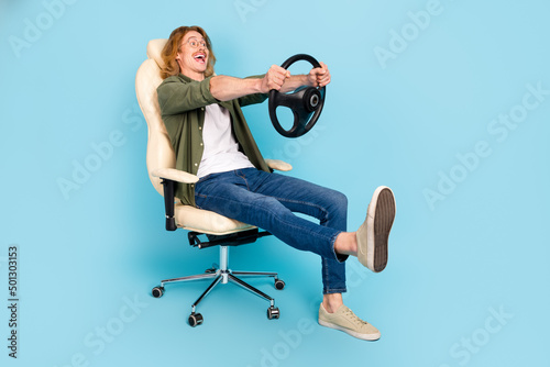 Wallpaper Mural Full length body size view of attractive cheerful guy sitting holding steering w
