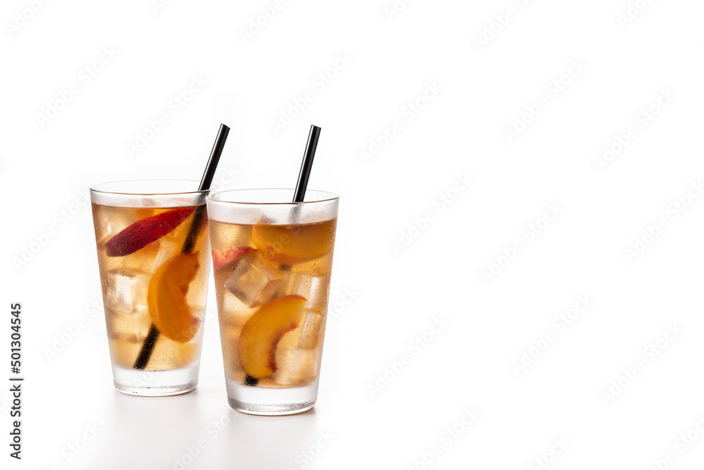 Glass of peach tea with ice cubes isolated on white background. Copy space Glass of peach tea with ice cubes isolated on white background. Copy space