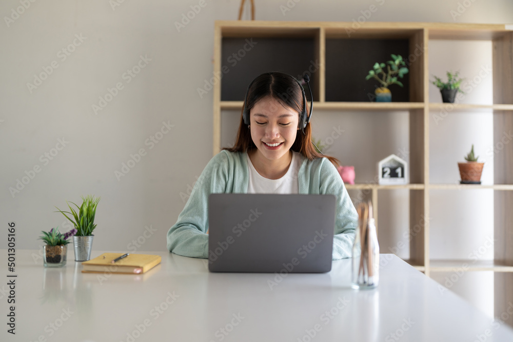 Happy young woman studying online, watching webinar, podcast on laptop. E-learning concept Happy young woman studying online, watching webinar, podcast on laptop. E-learning concept