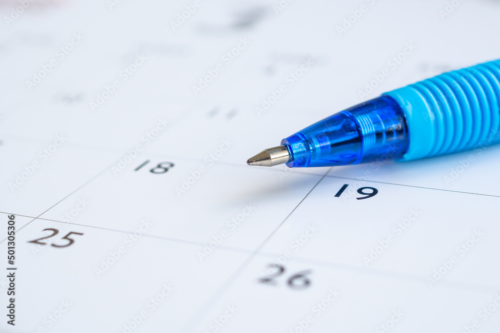Blue pen on calendar page background business planning appointment meeting concept Blue pen on calendar page background business planning appointment meeting concept