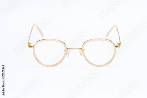 Fashion sunglasses white and gold frames on white background.