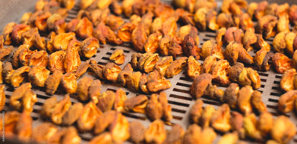 The process of home cooking dried fruits in an electric dryer.