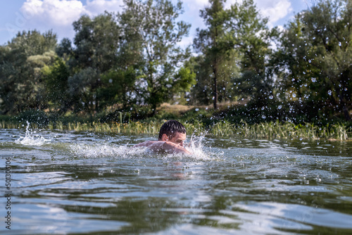 The young man swimming in the river © bearok