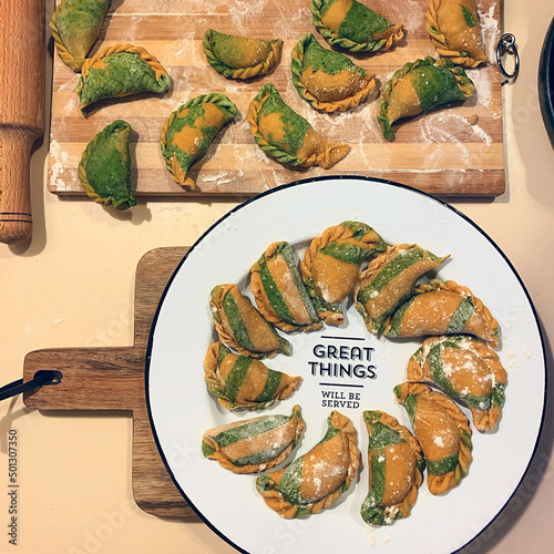 Dumplings - russian pelmeni, ravioli with meat on a white plate. Flat lay composition. Food