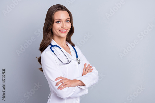 Profile side photo of young cheerful pretty physician crossed hands diagnostic isolated over grey color background