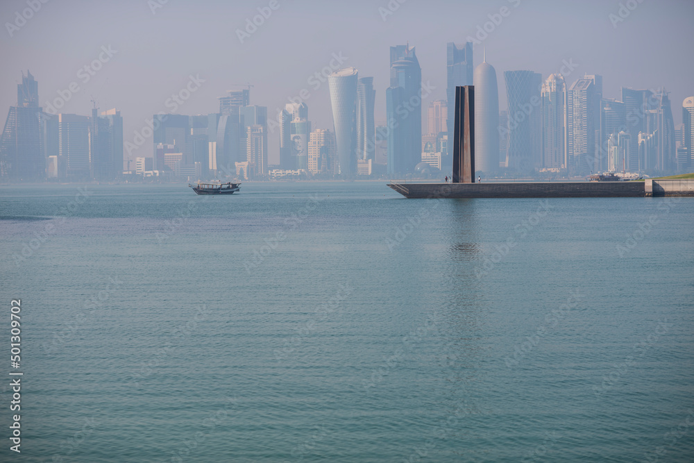 Fototapeta premium Doha,Qatar- April 24,2022 : Traditional dhow boats with the futuristic skyline of Doha in the background.