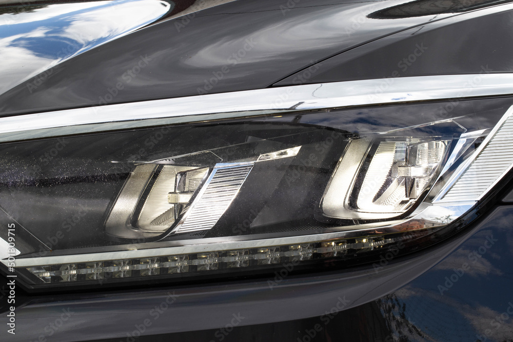 Obraz premium Economical and modern car headlight with LED adaptive light. Close-up, illuminate