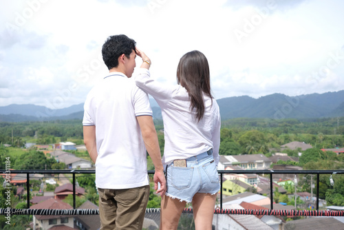 Young adults playing each other from behind and beautiful scene background