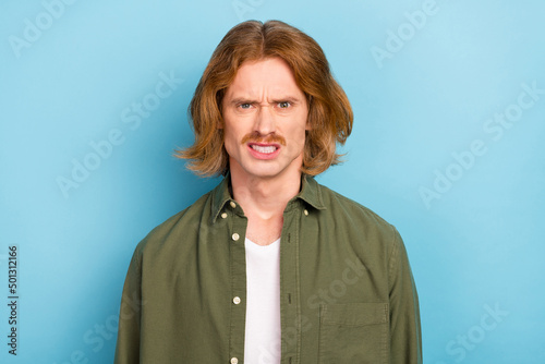 Portrait of attractive funky crazy mad fury annoyed red-haired guy bad mood isolated over bright blue color background