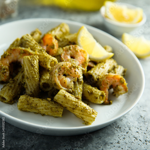 Pasta with pesto sauce and shrimps
