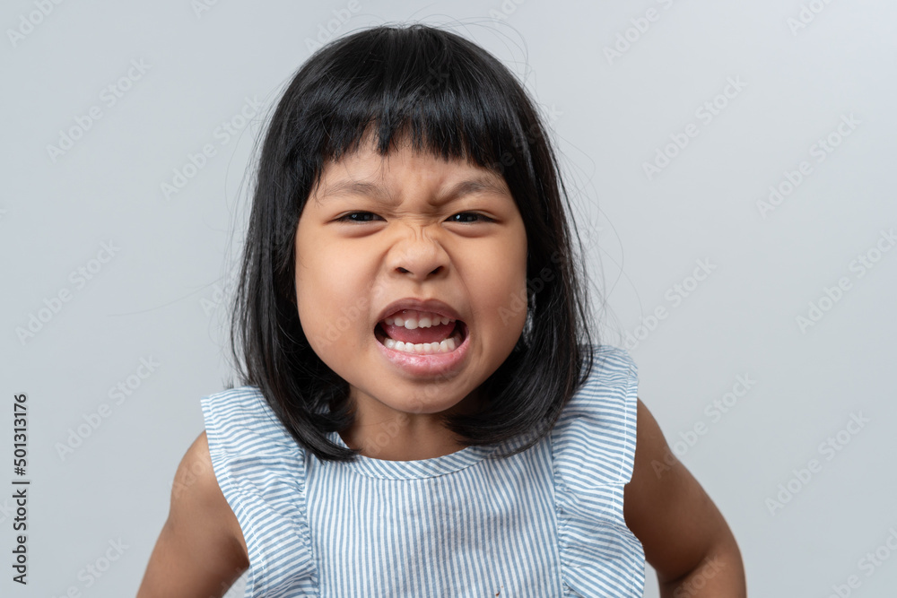 Portrait of angry emotional Asian girl screaming and frustrated shouting with anger, crazy and yelling on white background, Concept of attention deficit hyperactivity disorder (ADHD) Portrait of angry emotional Asian girl screaming and frustrated shouting with anger, crazy and yelling on white background, Concept of attention deficit hyperactivity disorder (ADHD)