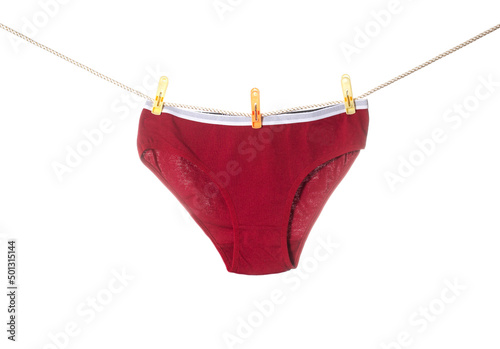 Stylish women's red panties hang on a clothesline after washing. White background, isolate