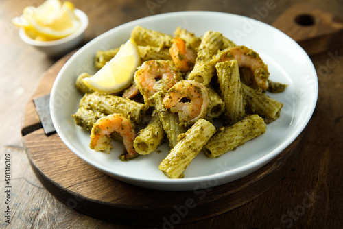Pasta with pesto sauce and shrimps