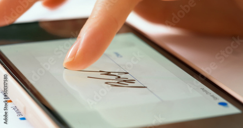 Sign document of deal on digital gadget. Digital signature on smartphone screen with woman hand. Close up.