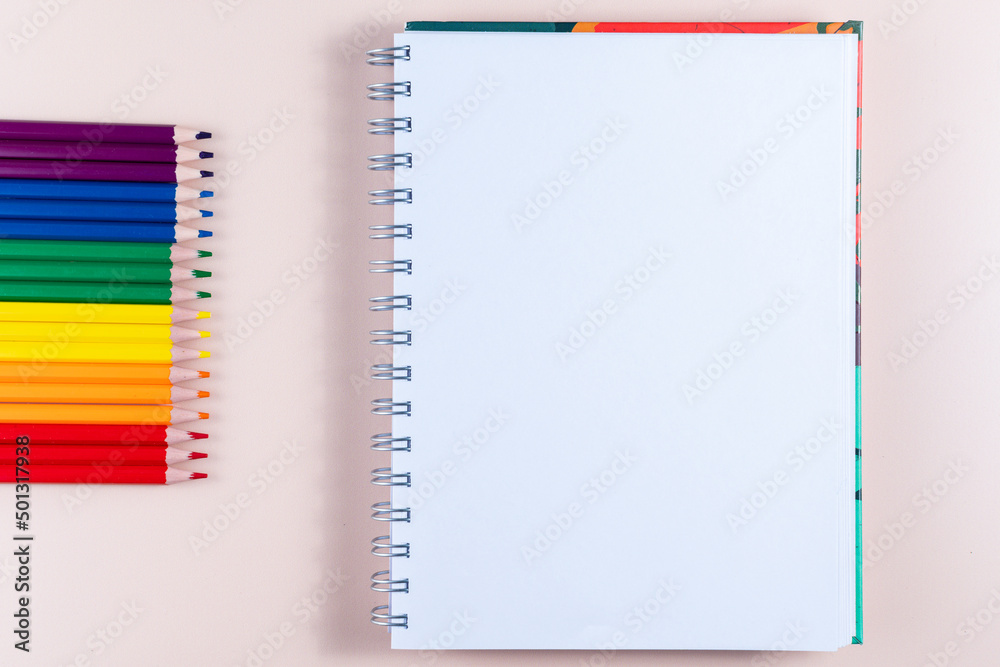 Pencils with the colors of the lgbt flag, a notepad and copy space. Pencils with the colors of the lgbt flag, a notepad and copy space.