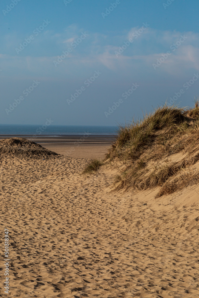 The coast at Formby in Merseyside, with a blue sky overhead The coast at Formby in Merseyside, with a blue sky overhead