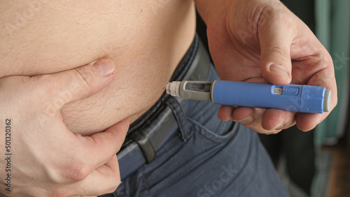 obese fat man injecting Semaglutide Ozempic injection control blood sugar levels