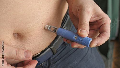 obese fat man injecting Semaglutide Ozempic injection control blood sugar levels