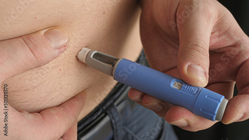 obese fat man injecting Semaglutide Ozempic injection control blood sugar levels