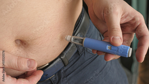 obese fat man injecting Semaglutide Ozempic injection control blood sugar levels